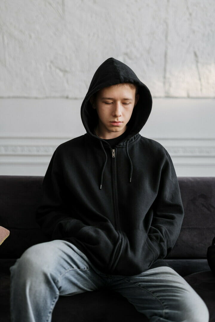 teenage male with clinical depression sitting on a couch